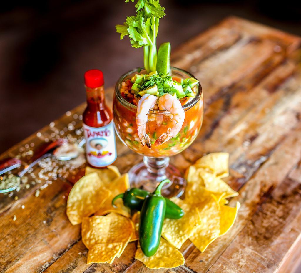 Coctail de Camaron · Mexican style shrimp cocktail made with clamato juice, ketchup, chopped tomatoes, onions, cucumbers, fresh jalapeno peppers, cilantro, diced avocados, lime juice, and spices. Served with saltine crackers.