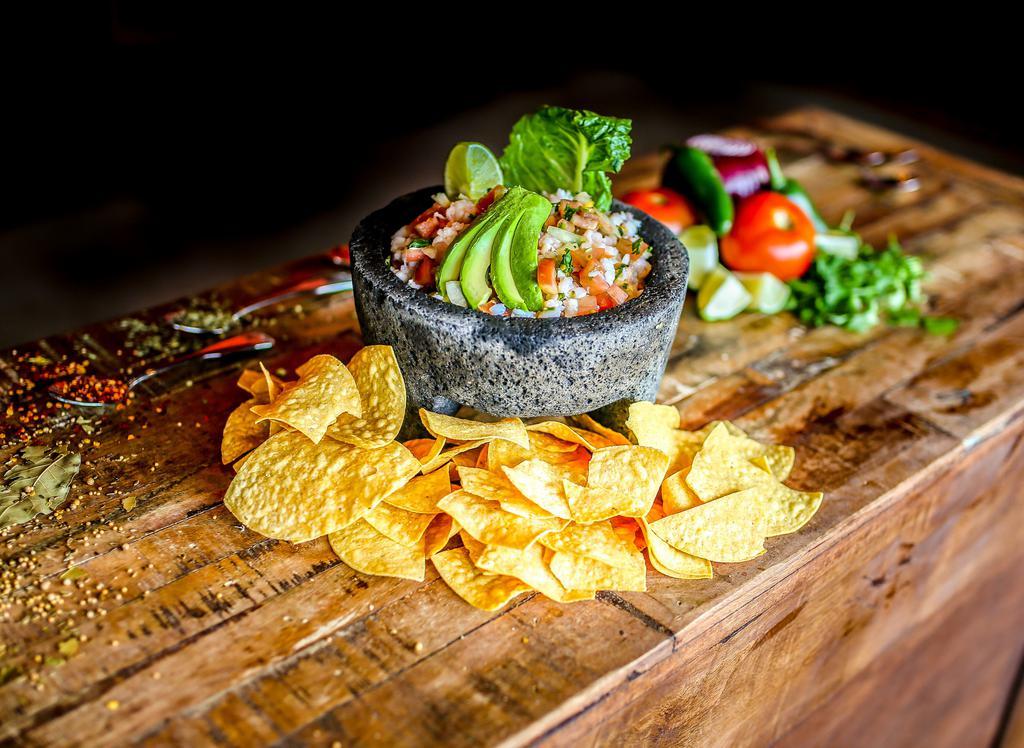Ceviche · Shrimp marinated in tangy lime juice tossed with tomato, cilantro, onions; garnished with sliced avocados and a fresh lime wedge. Gluten free.