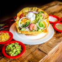 Taco Salad · Large flour tortilla fried into a tostada shell seated on refried beans. Tossed with crispy ...