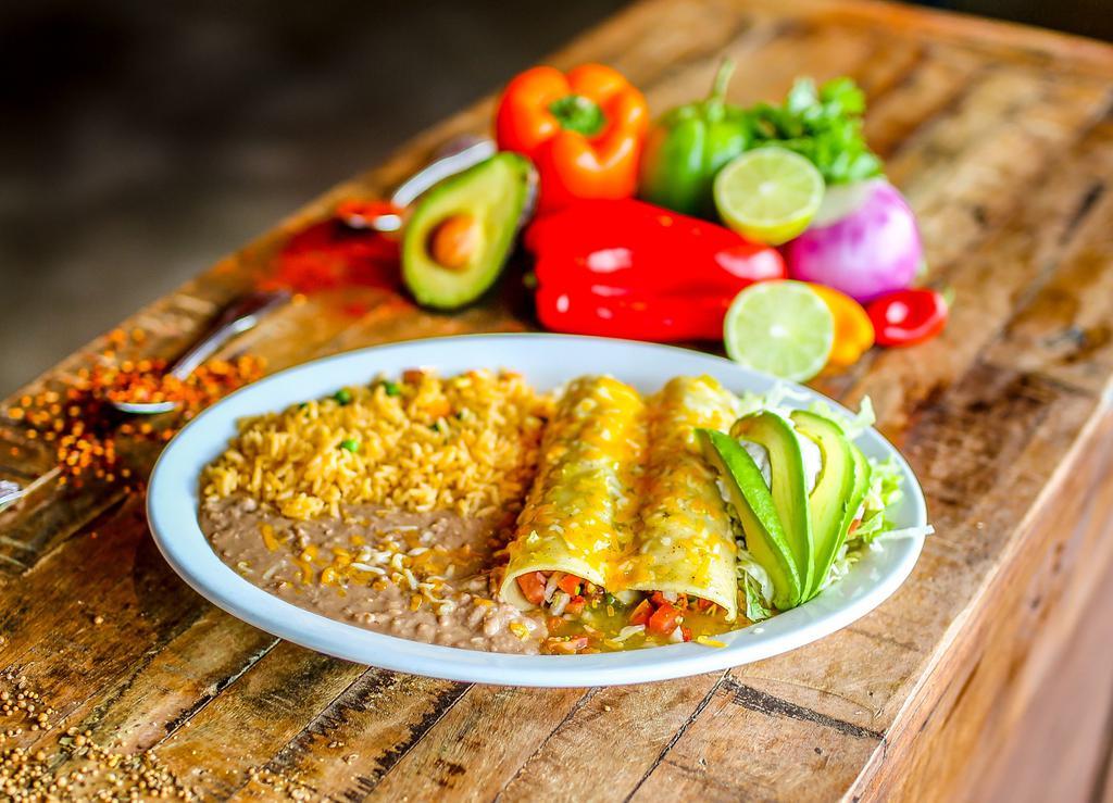 Enchiladas de Camaron · A pair of enchiladas stuffed with succulent shrimp sautéed in with tomatoes, onions and cilantro; topped with queso dip, lettuce, tomatoes, and avocado slices. Served with Mexican rice and refried beans.