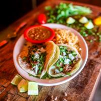 Grilled Steak Tacos · Three traditional soft corn tortillas filled with tender chargrilled steak, cilantro and oni...