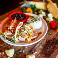 Tacos de Pescado · Gluten-free. Two grilled tilapia fish tacos served on a flour tortilla topped with shredded ...