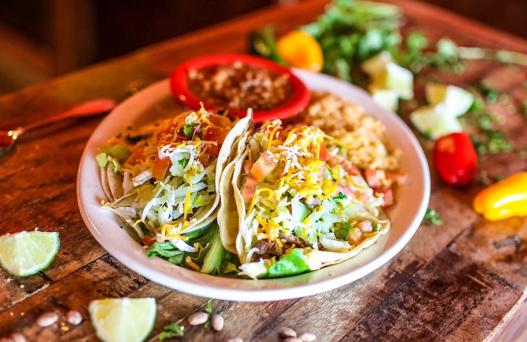 Arandas Steak Tacos · Three traditional soft corn tortillas filled with tender steak, pico de gallo, lettuce and mixed shredded cheese. Served with whole beans and Mexican rice.