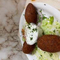 Kibbeh · Minced beef onions & pine nuts mixed with our own zesty spices - wrapped in bulgur crust