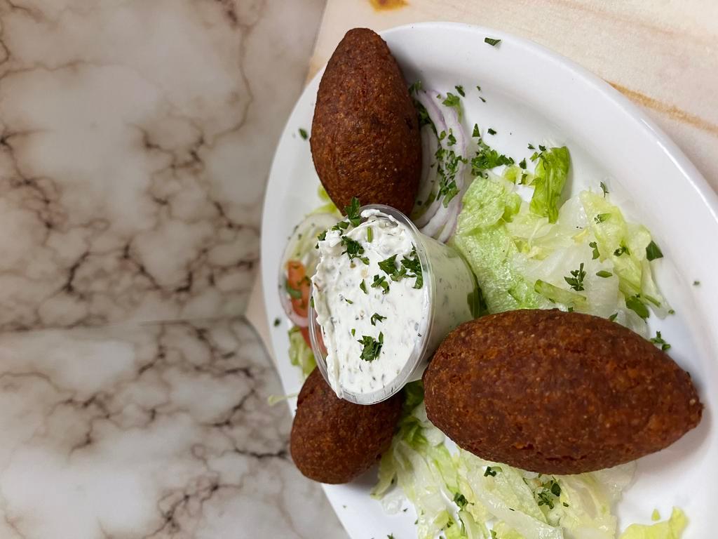 Kibbeh · Minced beef onions & pine nuts mixed with our own zesty spices - wrapped in bulgur crust