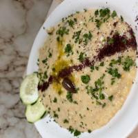 Baba Ghanoush · Roasted mashed eggplant mixed with tahini sauce fresh garlic & spices - served with pita