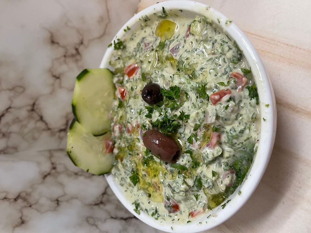 Jerusalem Salad · Fresh tomato & cucumber mixed into our creamy tahini sauce