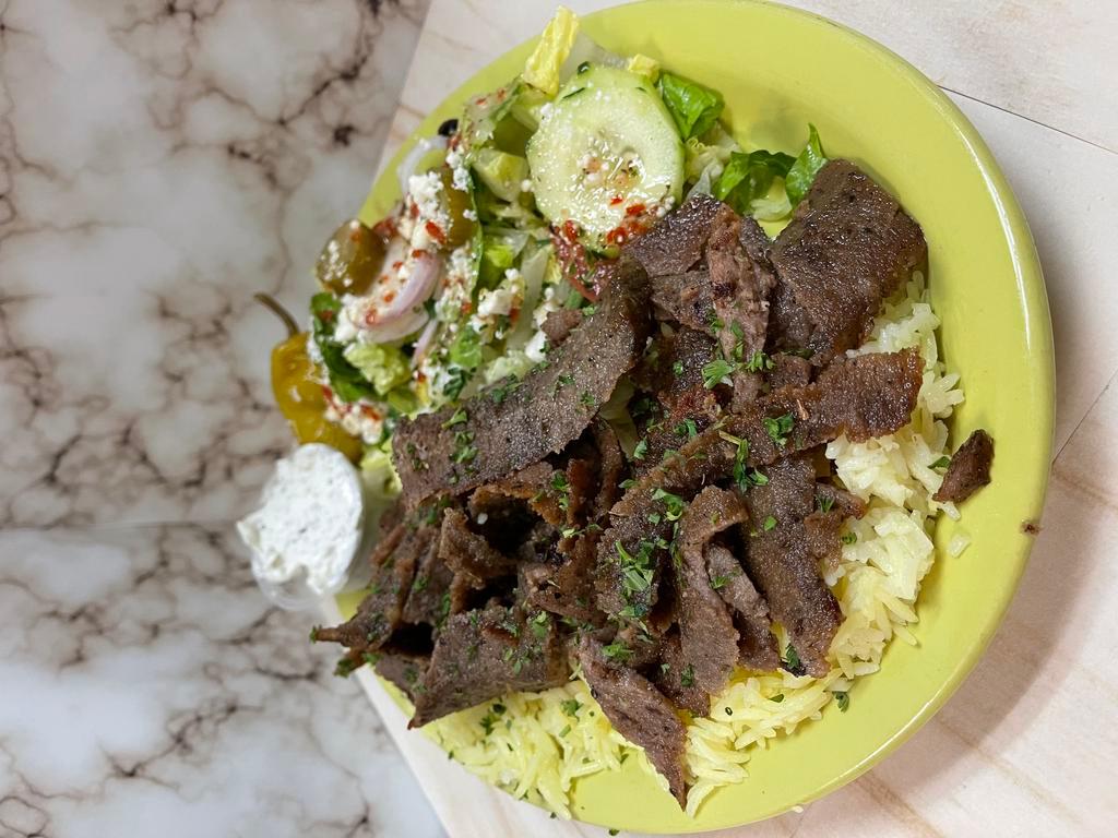Gyro Plate · Thinly cut mixture of lamb & beef mixed with our special spices - served with tzatziki sauce salad rice & pita