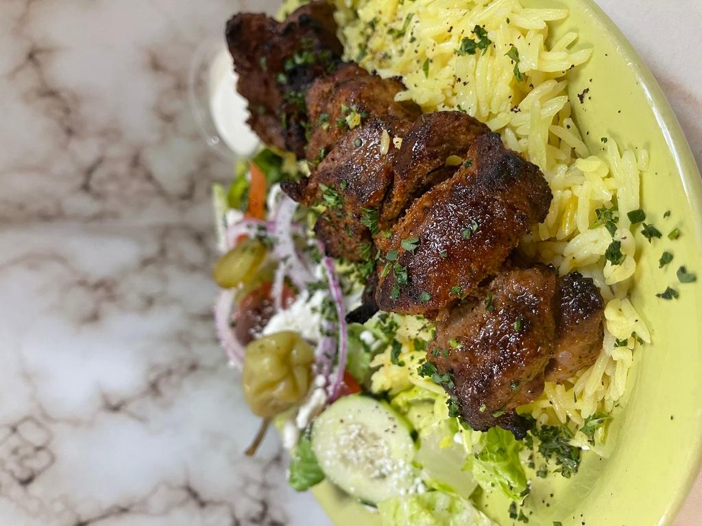 Lamb Kabob Plate · Flame grilled marinated cubed lamb cooked with our special seasoning - served with salad rice & pita