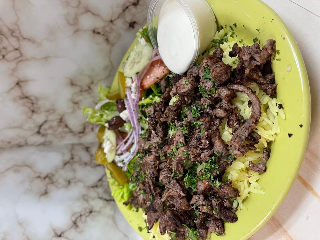 Beef Shawarma Plate · Thinly sliced marinated boneless beef mixed with our special spices - served with salad rice & pita