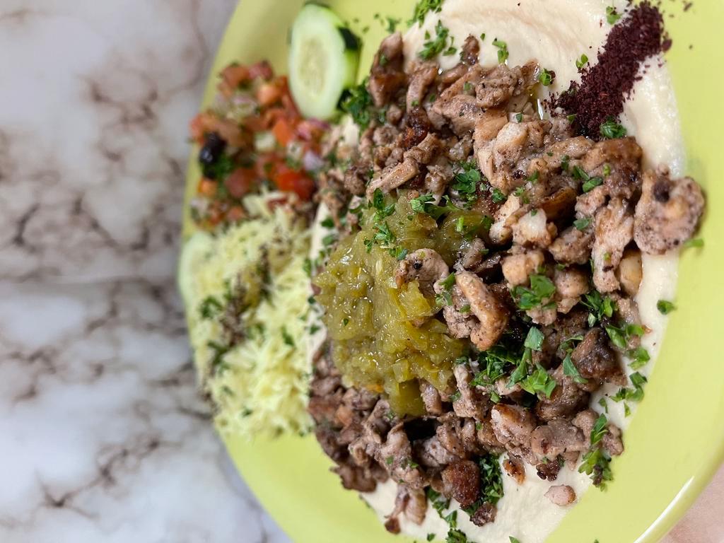 Hummus with Meat Shawarma · Hummus topped with your choice of chicken or beef shawarma - served with salad rice & pita