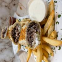 Beef Shawarma Wrap · Beef shawarma wrapped with tortilla bread with pickle onion tomato & garlic sauce - served w...