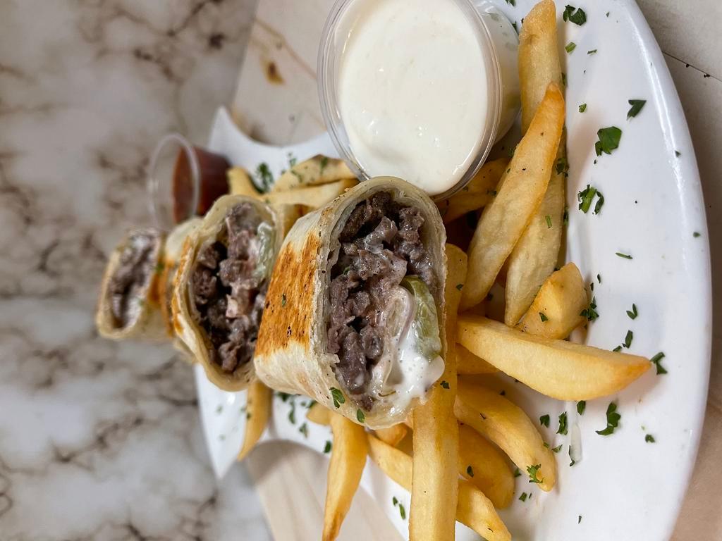 Lamb Shawarma Wrap · Lamb shawarma wrapped with tortilla bread with pickle onion tomato & garlic sauce - served with fries