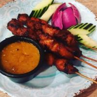 Satay Chicken · Grilled marinated skewers are served with a peanut sauce that’s so tasty, you’ll want to sav...
