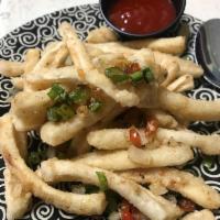 Crispy Spicy Calamari · Tender pieces of squid are wok-fried and topped with a sweet chili “ketchup”.
