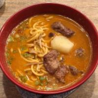 Malaysian Curry Noodle Soup Dinner · Fresh egg noodles are served with red onions and bean sprouts in a big bowl of mildly spicy ...