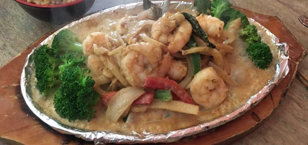 Sizzling Chili Leaf Shrimp · Caramelized shrimp are sautéed with fragrant chili leaves, shredded bell peppers, and onions. Gluten free.