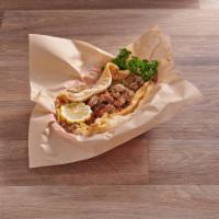Shawarma Sandwich · Tender marinated chicken or lamb shawarma with lettuce, tomato, onion, parsley and tzatziki....