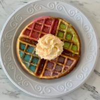 Unicorn Waffle (vegan) · 7' Belgian waffle topped with multi-colored glaze, whipped cream, and sprinkles.