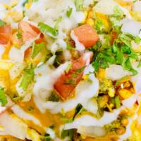 Samosa Chaat · Pieces of samosa served with chickpeas and topped with yogurt, fresh tamarind sauce and mint...