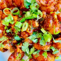 Lasuni Gobi · Crispy cauliflower cooked with ginger-garlic spicy sauce. Vegan.