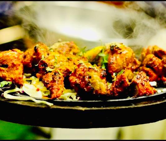 Chicken Reshmi Kabab · Mouthwatering and succulent pieces of chicken and coriander in tomatoes and onions marinated with Indian spices and cooked in a clay oven.