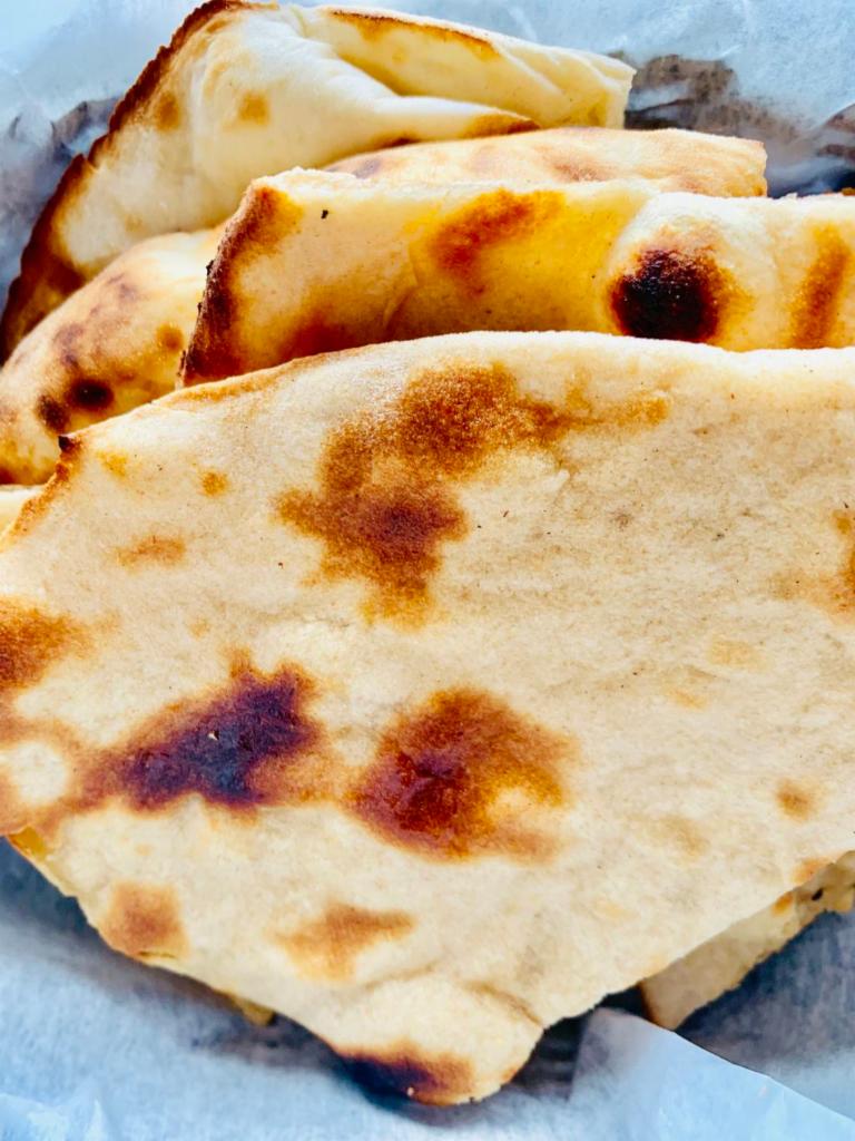 Tandoori Roti · An unleavened whole-wheat bread. Served plain or with butter.