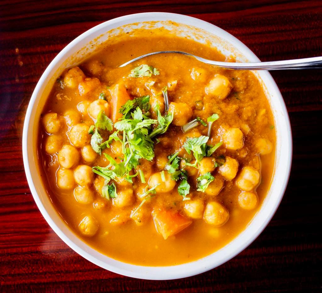 Chana Masala · Chickpeas, onions and ginger cooked in with Indian spices and tomato sauce. Vegan.
