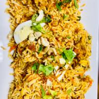 Chicken Biryani · Long grain basmati rice cooked with succulent pieces of chicken and blended with exotic Indi...