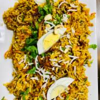 Goat Biryani · Succulent pieces of goat with bone cooked with basmati rice over a low-fire with aromatic In...