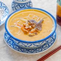 35. Panang Curry · Thai panang curry with coconut milk, green beans, bell peppers and shredded kaffir lime leav...