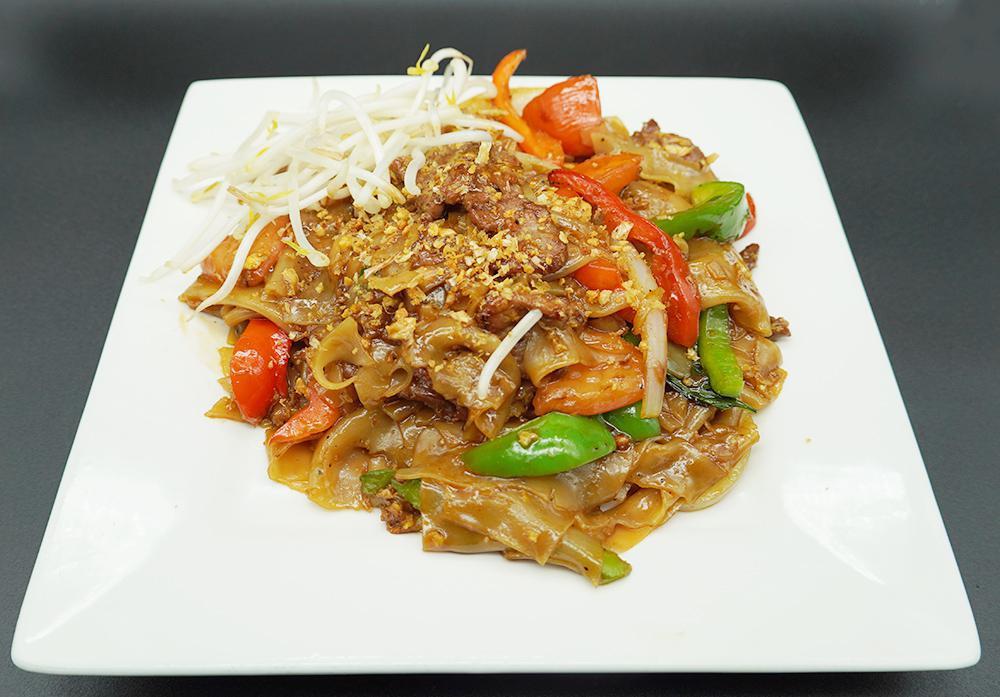 59. Pad Drunken Noodle · Stir fried flat noodles with egg, bell pepper, sweet basil leaf, tomato and onion. Served with fresh bean sprouts. Spicy.