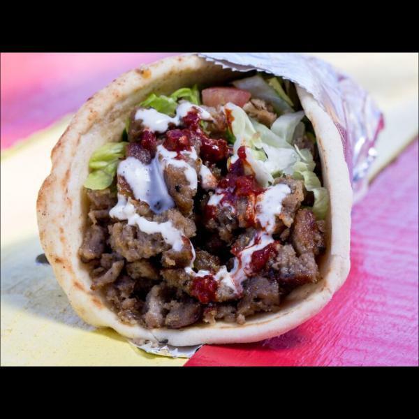 11. Gyro Wrap · Lamb thinly sliced and grilled with lettuce, tomato, cucumber in pita bread. Includes signature white sauce and hot sauce.