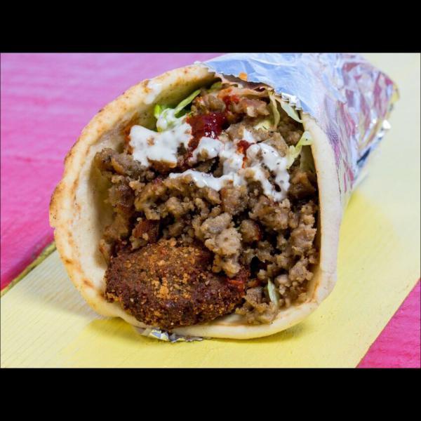 15. Gyro and Falafel Wrap · Grilled, thinly spiced lamb and beef, fried veggie balls with lettuce, tomato, cucumbers in pita bread. Includes signature white sauce and hot sauce.