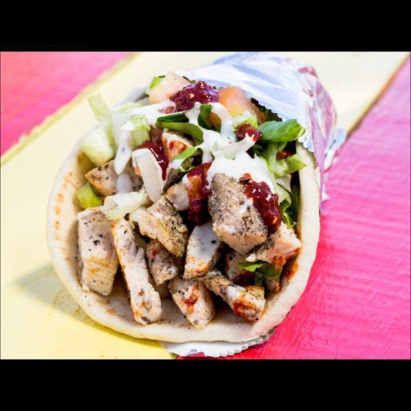 16. Chicken Shawarma Wrap · Marinated chicken breast, thin sliced wrapped in pita bread with tomato and onions. Includes signature white sauce and hot sauce.