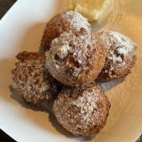 Hushpuppies  · Fried hushpuppies dusted in powdered sugar. Served with honey butter. 