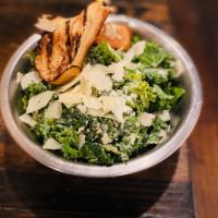 Tossed Kale Caesar Salad · Fresh kale greens tossed in caesar dressing, shaved parmesan, with a side of grilled brioche...