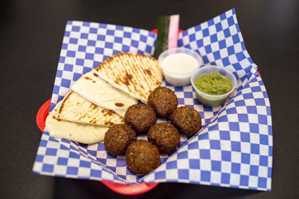 Falafel · Chickpea and veggie fritter lightly fried, served with fresh grilled pita, sesame tahini sauce, and jalapeno cilantro shug sauce.