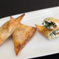 Spanakopita Wontons · 6 feta and spinach stuffed wontons lightly fried and served with tzatziki sauce.