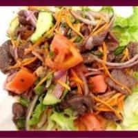 21. Yumnau Salad · Steak salad. Slice grilled steak mixed with lime juice, chili, onions, tomatoes, cucumbers, ...