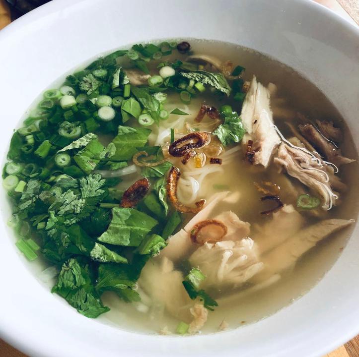 Chicken Pho · Rice noodles in a decadent choice of beef or veggie broth topped with slices of dark chicken meat garnished with a medley of fresh cilantro & onions.