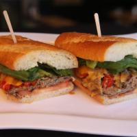 Hot Roast Beef Sandwich · Grilled lean roast beef with cheddar cheese, sauteed red bell peppers and onions, with romai...