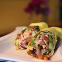 BBQ Chicken Wrap · Grilled chicken, crispy bacon, romaine lettuce, tomato and red onion with our BBQ ranch dres...