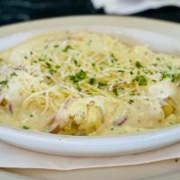 BAKED CAULIFLOWER · Baked cauliflower and onions in garlic lemon sauce, topped with Parmesan cheese and fresh It...