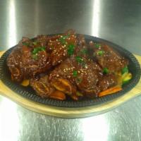 60. BBQ Short Ribs · Galbi. Marinated short rib with special sauce. Served with rice, miso soup and salad.