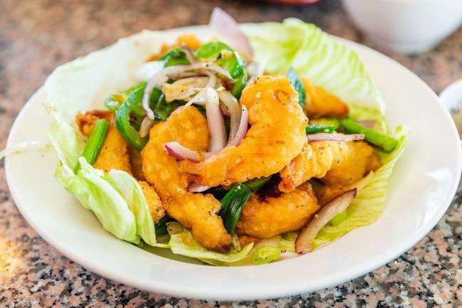 Dynamite Shrimp · Shrimp dipped in tempura batter, fried crispy.  Wok-tossed with garlic, jalapenos, white onion, spring onion & house spices.  Served with house lime sauce.