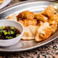 Pork Dumplings · (8) Pork, cabbage, green onions, wrapped in wheat dough.  Served steamed or fried with a sid...