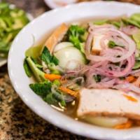 Vegan Pho. · Vegan broth noodle soup with sliced fried tofu, broccoli, snow peas, bok choy, mushroom, & c...