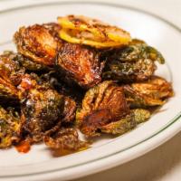 Crispy Brussels Sprouts · Drizzled with date vinegar and lemon slices