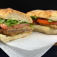 Milanesa Sandwich · Beef lightly breaded, mayo, lettuce, and tomatoes.